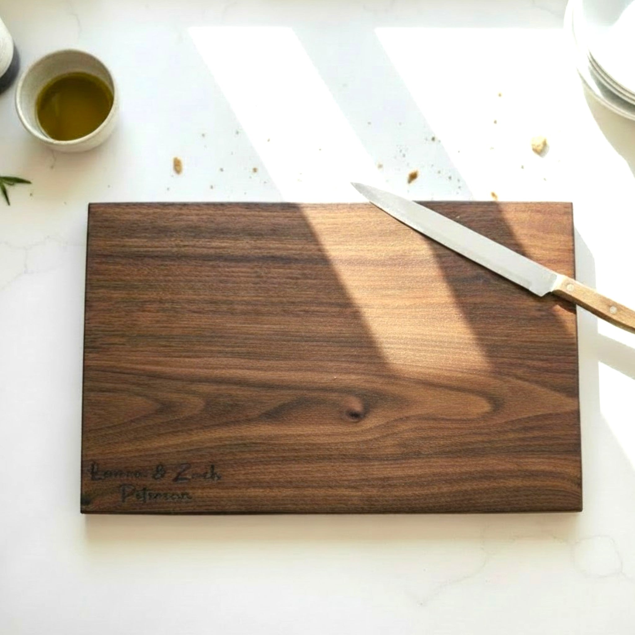 Black walnut wooden cutting board with personalized laser engraved text