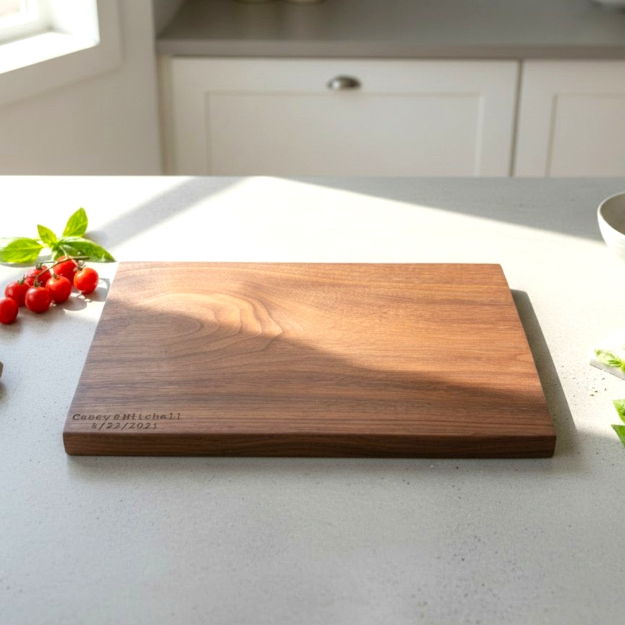Black walnut wooden cutting board with personalized laser engraved text