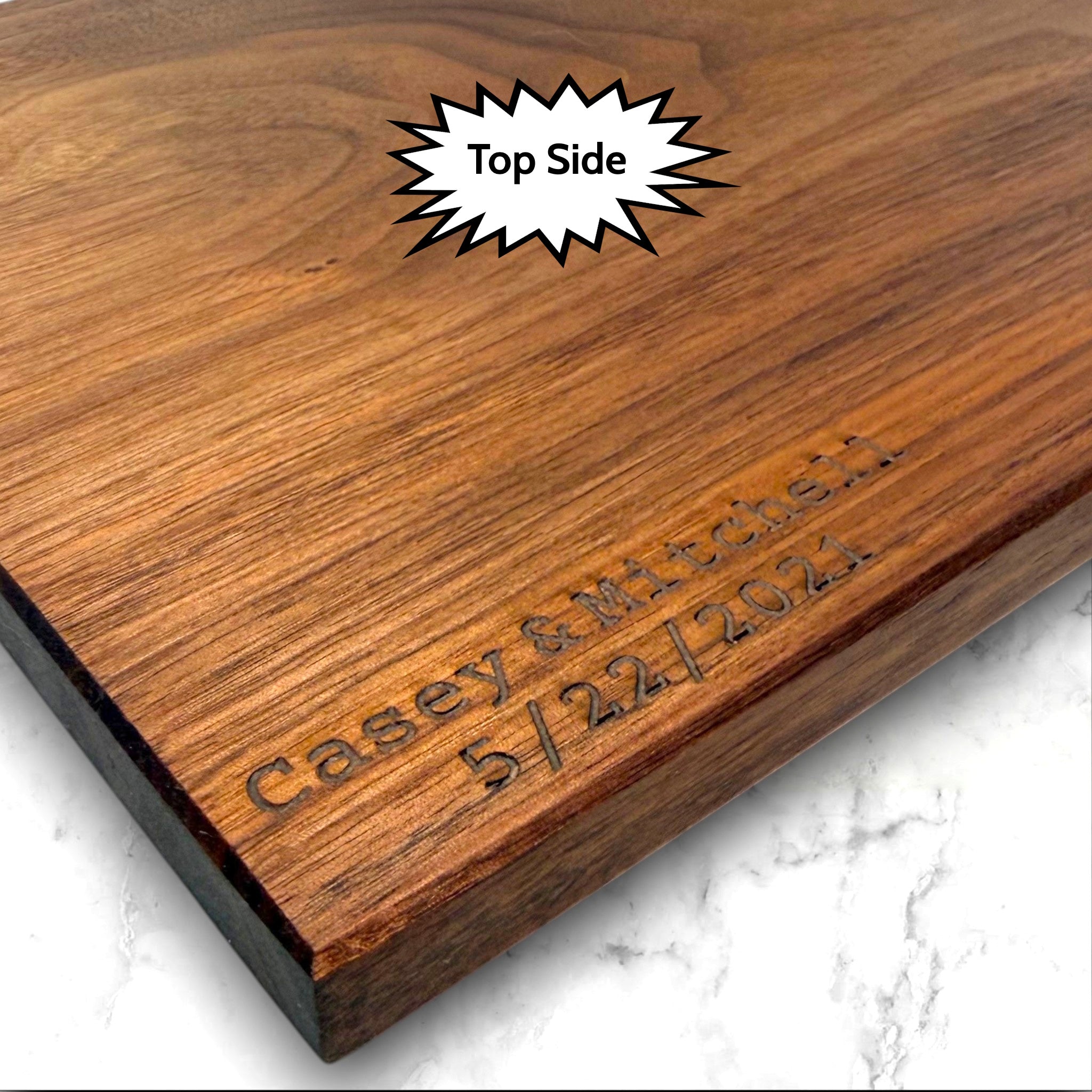 Black walnut wooden cutting board with personalized laser engraved text