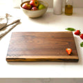 Live edge black walnut wooden cutting board with personalized laser engraved text