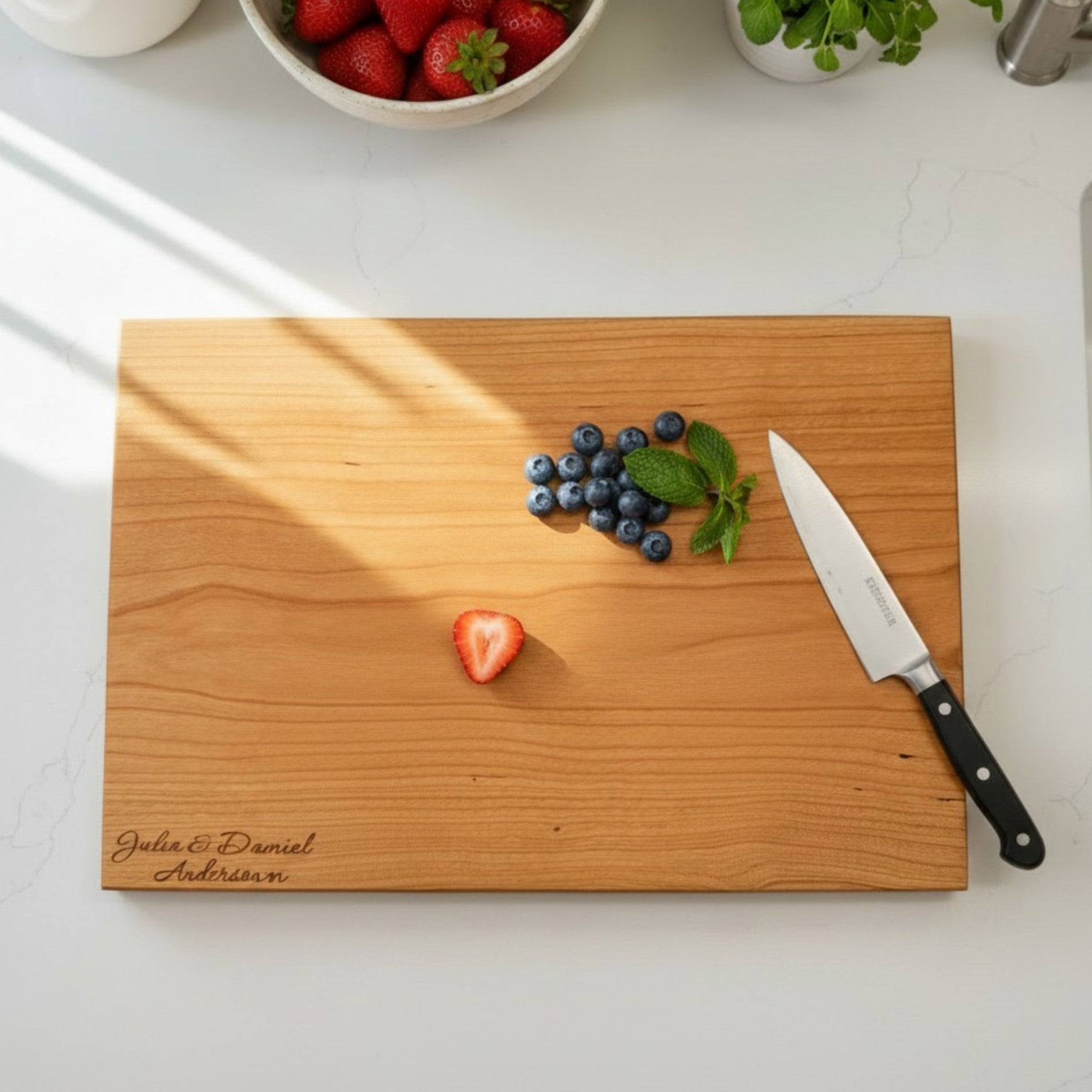 Cherry wooden cutting board with personalized engraving on a kitchen counter.
