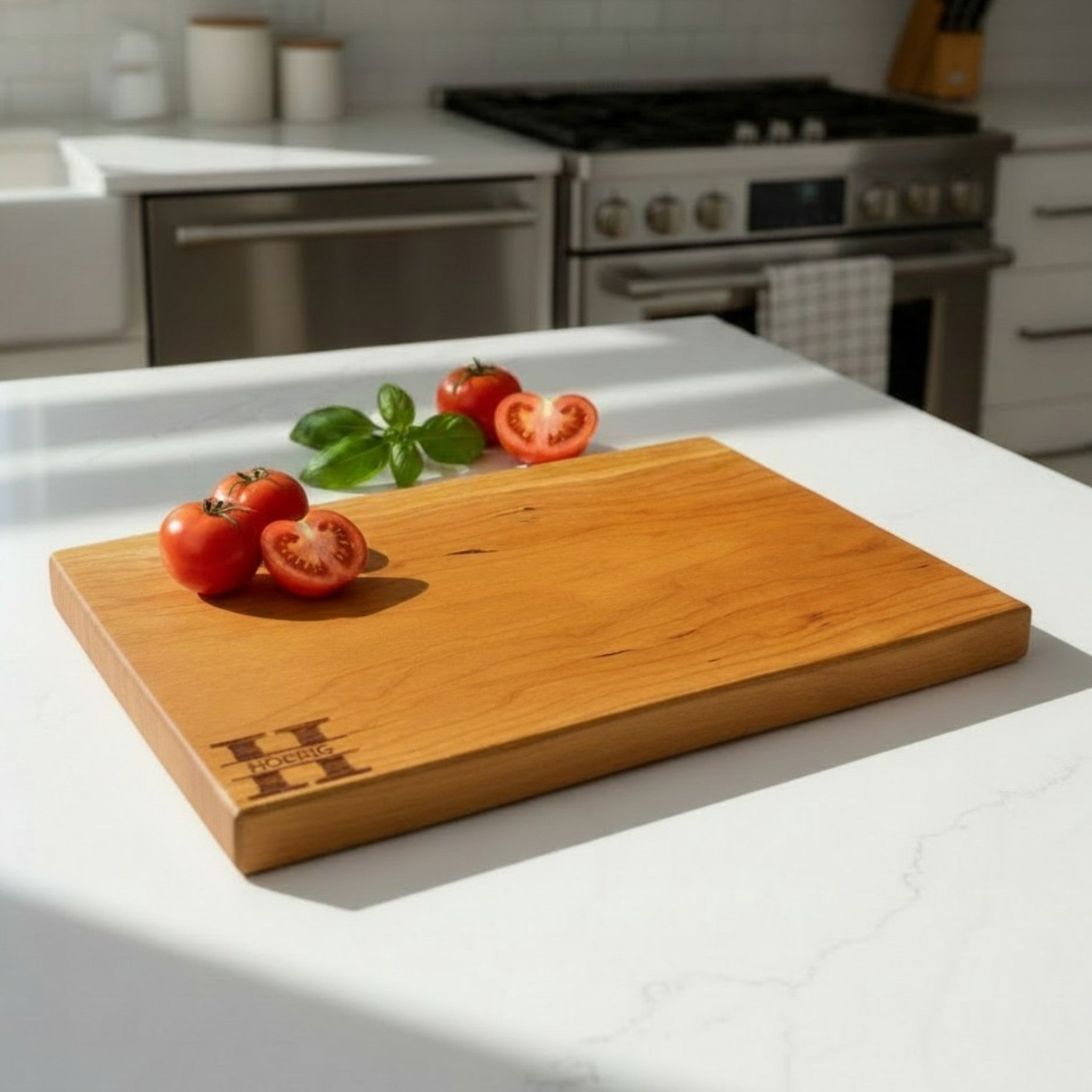 Cherry wooden cutting board with personalized engraving on a kitchen counter.