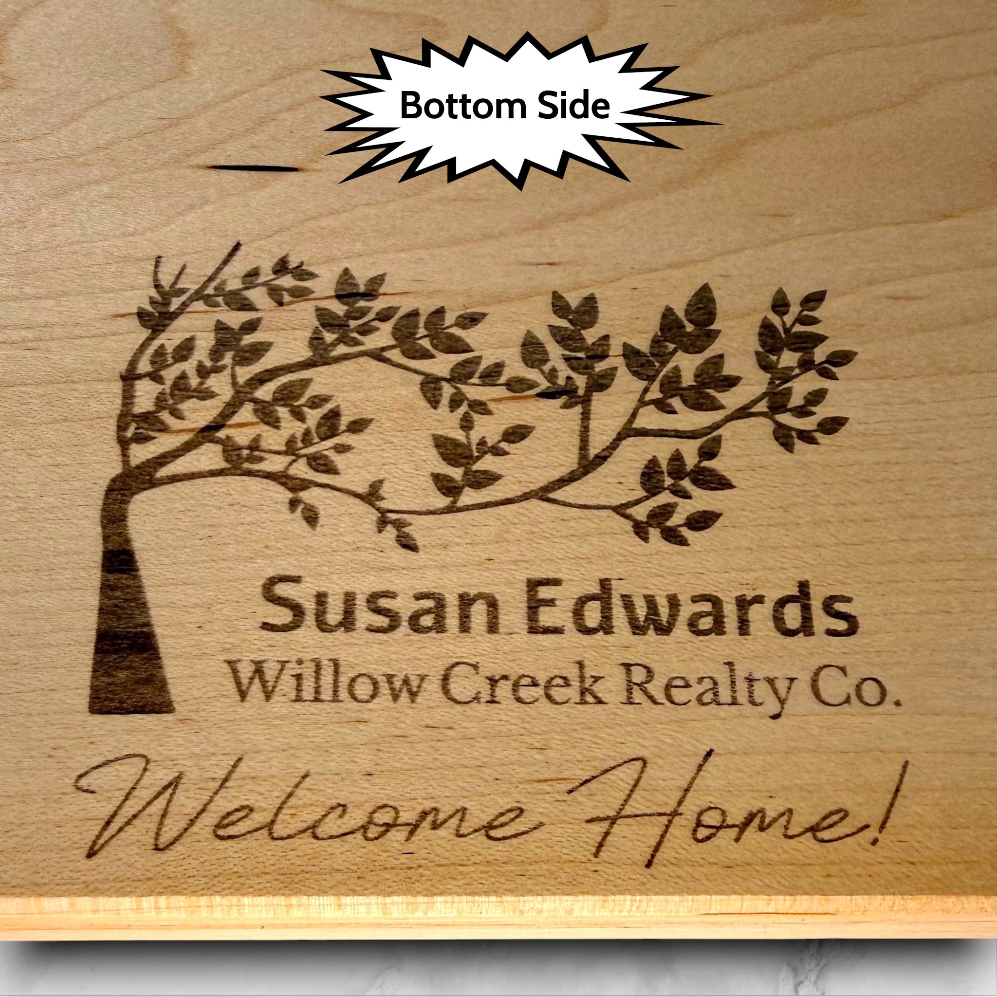Wooden maple cutting board with engraved tree design and text