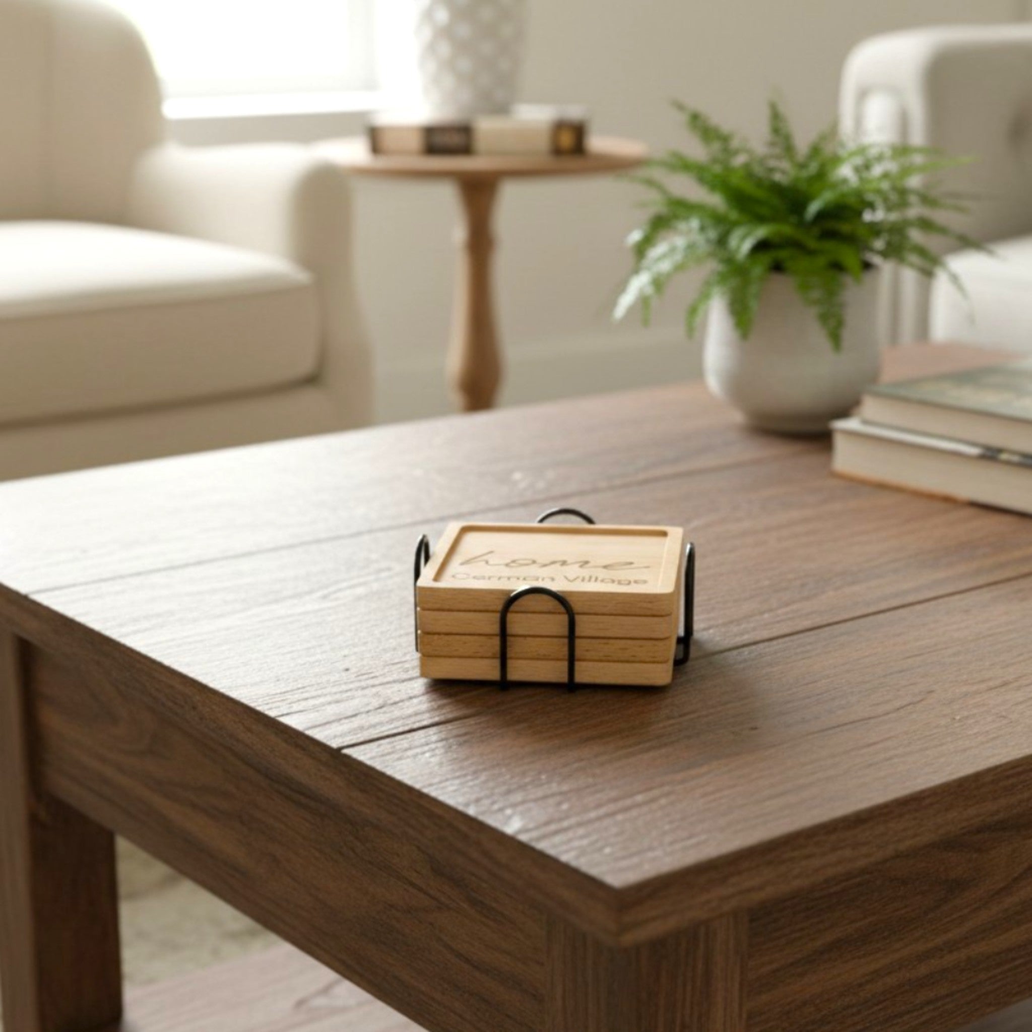 Stack of beech wooden coasters with a personalized design, sitting on a table