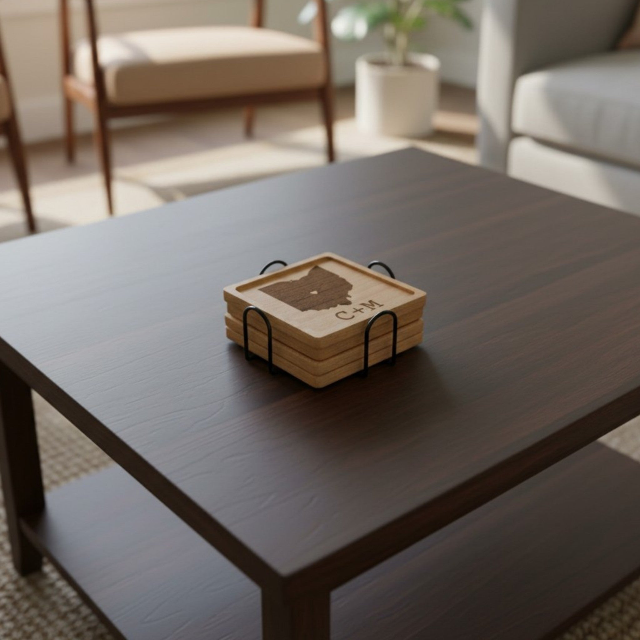 Stack of beech wooden coasters with a personalized design, sitting on a table