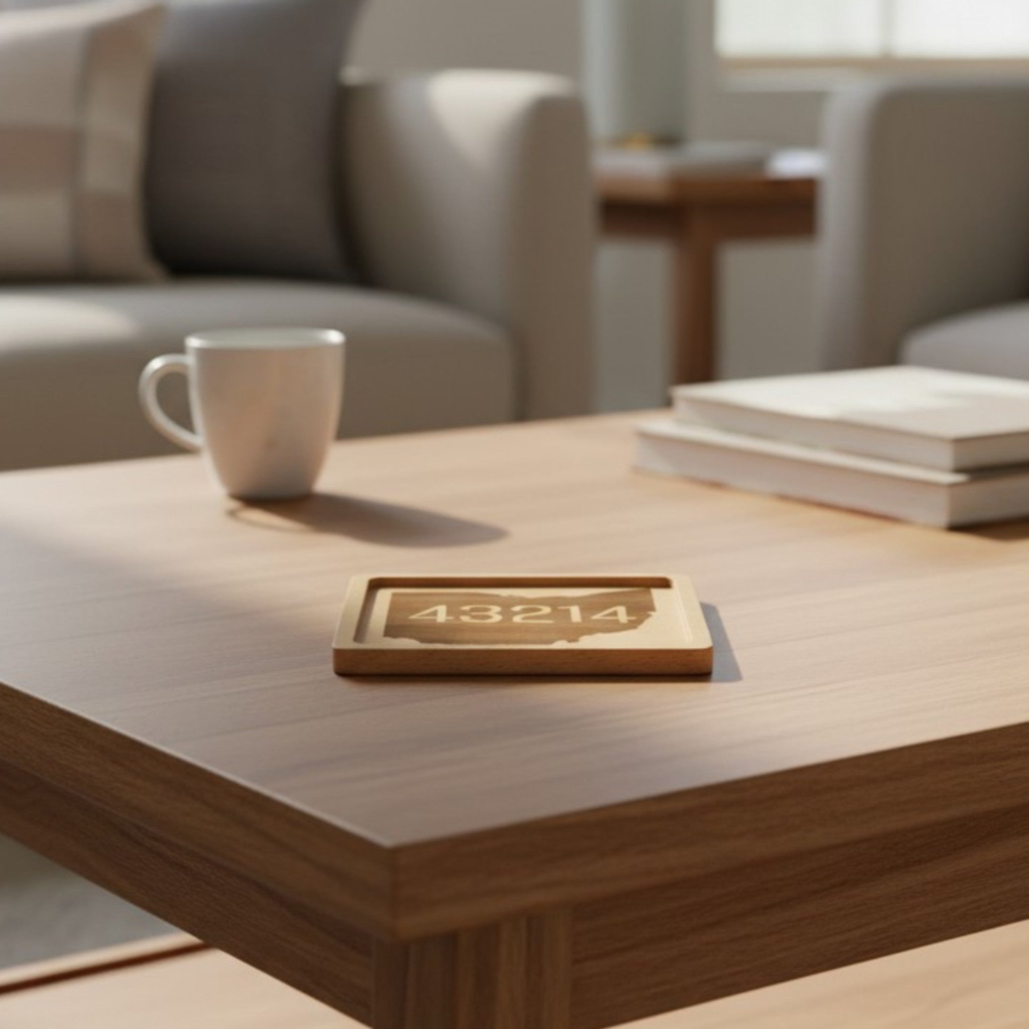 Wooden coaster made of beech featuring a personalized laser engraved design, sitting on a table.